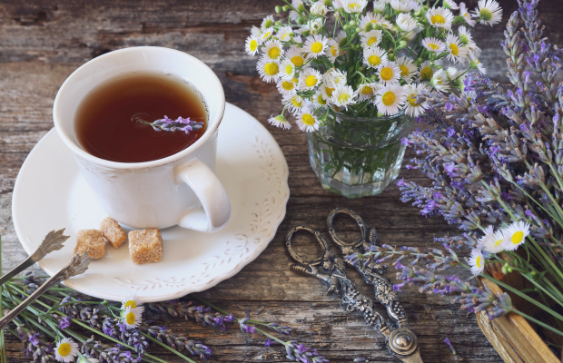 image of a cup of tea with lavender springs beside it